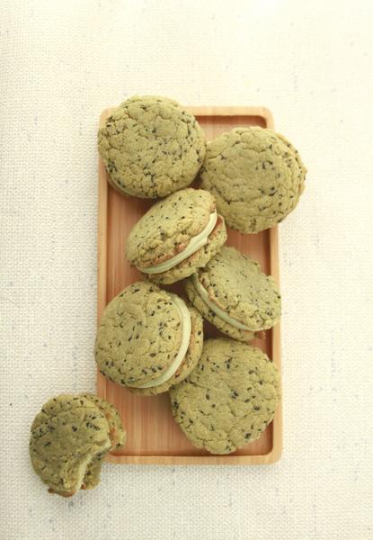 Matcha sandwich cookies arranged on parchment
