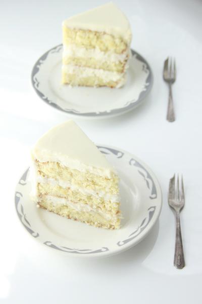 Savannah Coconut Cake slice on glass plate with dessert fork