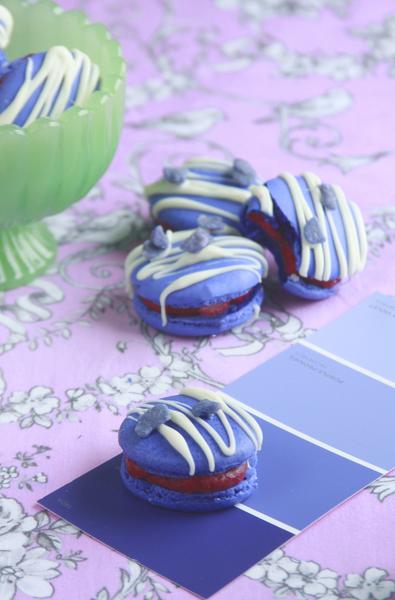 Violet cassis macarons on a patterned tablecloth